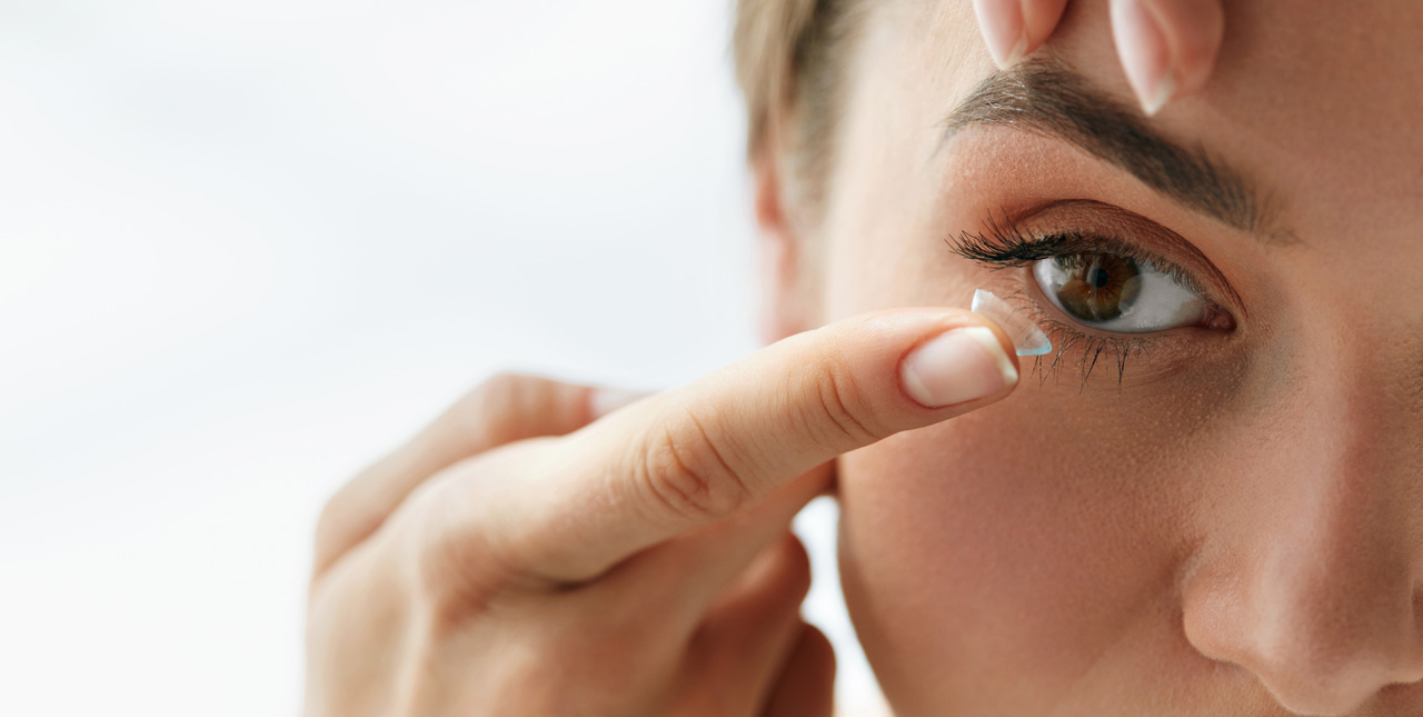 woman inserting contact-lens